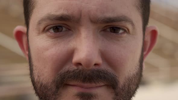 Outdoor Portrait of an Ugly Man Looking at the Camera with Serious Face alt