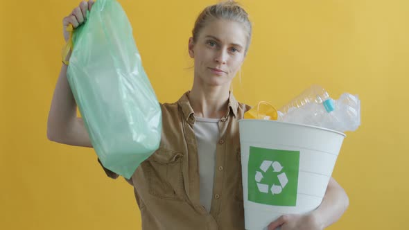 Slow Motion Portrait of Young Woman Holding Bags of Reusable Plastic Supporting Recycling alt