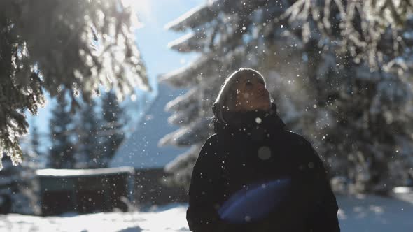 Young Woman Enjoying a Winter Day in Nature in Forest, Snowing on a Sunny Day, Slow Motion, Portrait