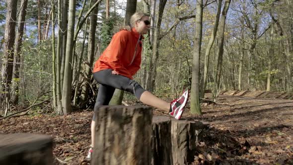 Woman Runner Stretching Leg Outdoors