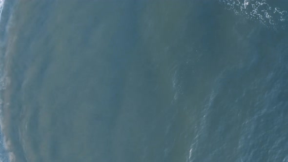 Top view of blue waves crashing loop