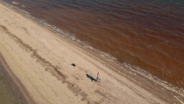 Two People Running By Sand Beach Coastline Sand Bar at Mykolaiv Region Ukraine alt