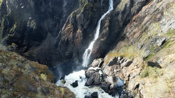 Aerial Dolly Forward To Reveal Overhead View Of Cascading Voringsfossen Waterfall In Norway. alt
