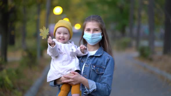 Masked Mother Holds Hand Lovely Daughter on Street Walk During Second Wave Quarantine Coronavirus alt