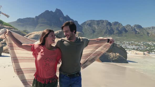 Couple running on beach alt