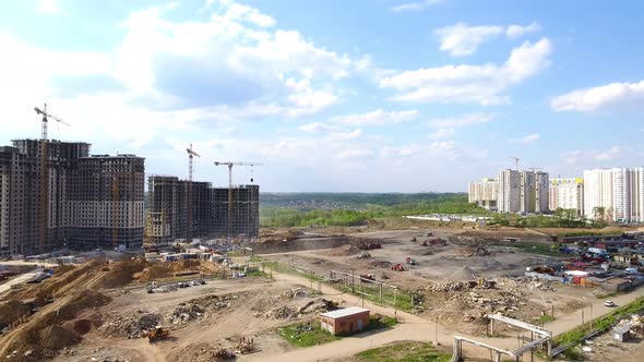 Drone flies over a construction site near Moscow. Construction cranes in the industrial zone. 