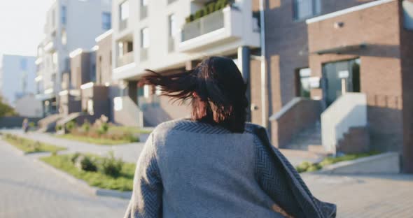 Woman Walking on City Street, Posing on Camera with Lovely Smile at Urban background alt