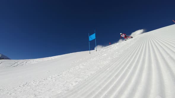 Low Angle View Professional Giant Slalom Skier During Training on Ski Piste alt
