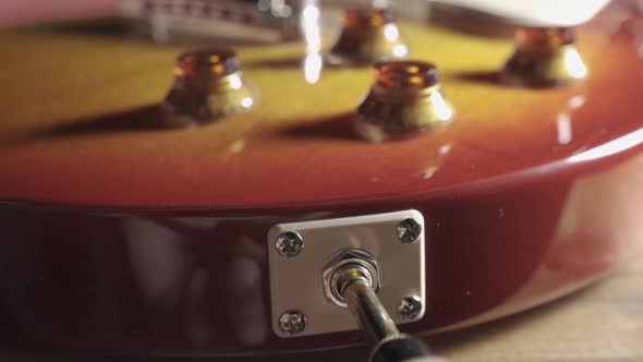 Insert Cable Jack Into Musical Instrument Electric Guitar alt