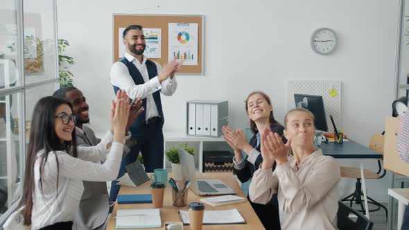Group of Employees Greeting New Worker with Carton Box Clapping Hands and Dancing alt