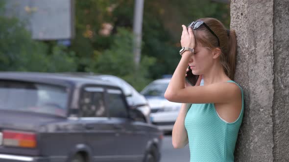 Sad Female Driver Speaking on Sellphone on Street Side Calling for Emergency Service After Car alt