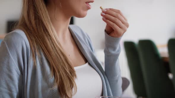 Pregnant woman taking vitamins at home. Shot with RED helium camera in 8K alt