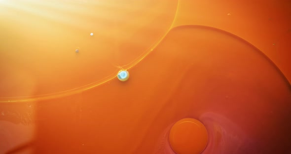 Abstract liquid orange and yellow colors dissolving on water. alt