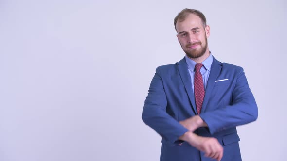 Happy Bearded Businessman Touching Something and Crossing Arms