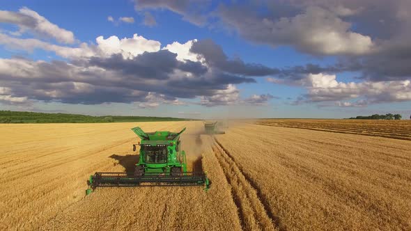 Combine Harvesters and Cloudy Sky. alt
