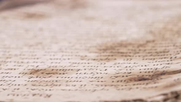 Slider Shot Over Pages with Candle Wax Stains of Old Antique Religious Book alt