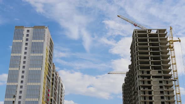 Clouds Move Over Two High-rise Buildings. Timelapse. Construction of a Residential Complex alt