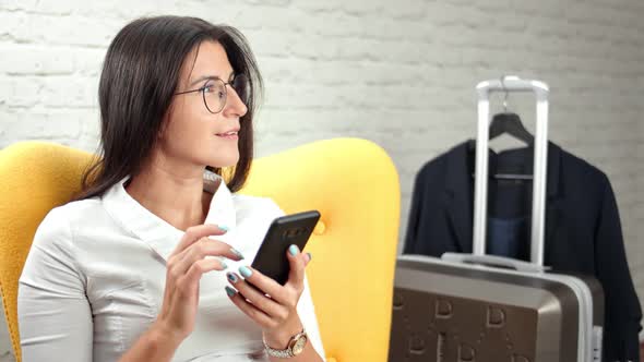 Busy Positive Stylish Young Businesswoman Chatting Using Smartphone During Business Trip alt