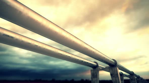 Endless animation of mid-cloudy sunset over the huge pipeline. Loopable. HD alt