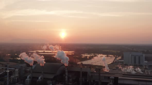 Aerial view Drone shot of flying around toxic chimneys tubing. Air Pollutants, Industrial zone.