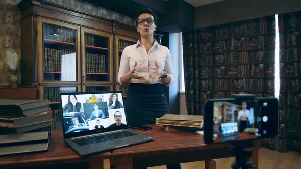 Librarian Is Teaching Adult Students During a Video Lesson alt