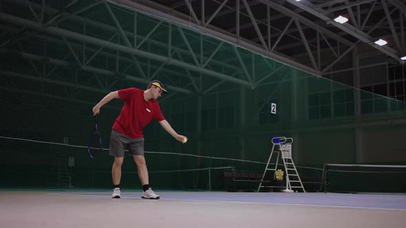 Serve of Professional Tennis Player on Indoor Tennis Court Training and Practicing Strikes By alt