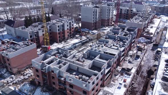 Aerial view of construction site in early spring with remaining snow.