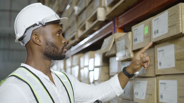 African male worker inspects merchandise stock