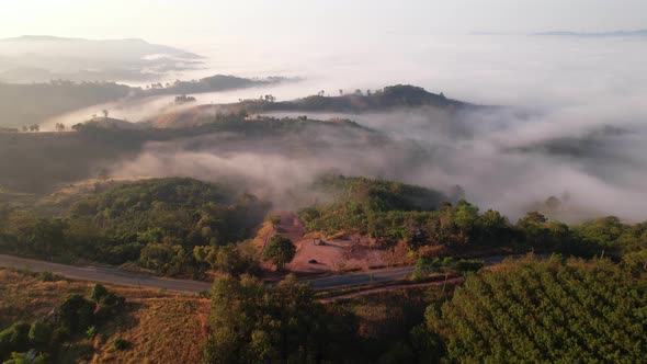 4K Aerial view from drone over mountains fog. Golden scenery at sunrise, Nan, Thailand alt