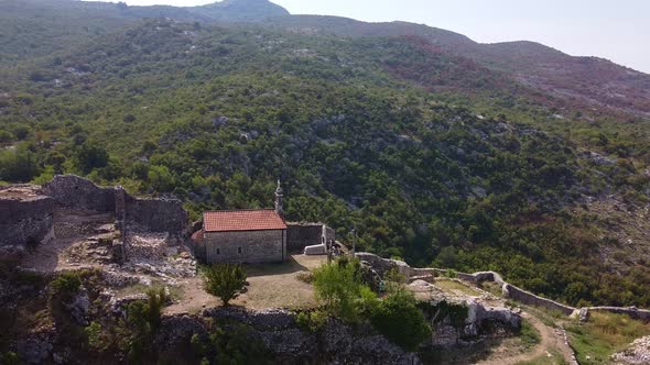 Stone Church with Red Tiles on the Top of the Rock