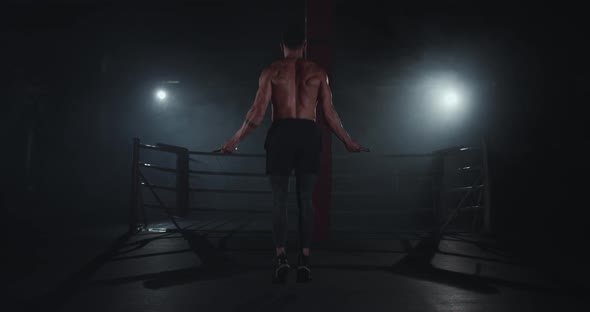 Bodybuilding Man Jumping Hard on the Rope in a alt
