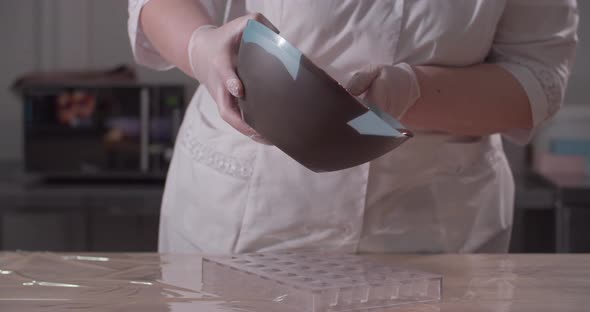 Pastry Chef Fills Forms with Chocolate
