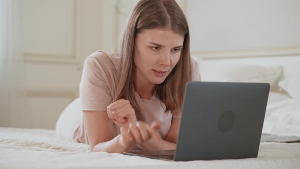 Jolly Female Use Computer in Apartment alt
