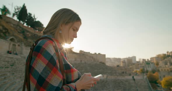Woman Uses Mobile Smartphone App in Amman Roman Theatre Jordan Middle East