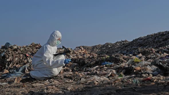 Scientist checking waste will be dumped at landfill site alt