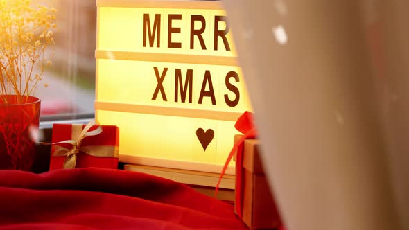 Merry Christmas on Light Box and Gifts on Window