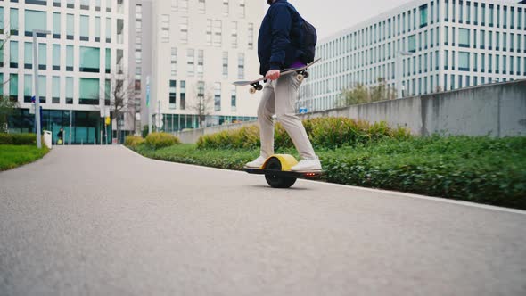 Close Up Leg Shot of a Skater with Electric Skateboard alt