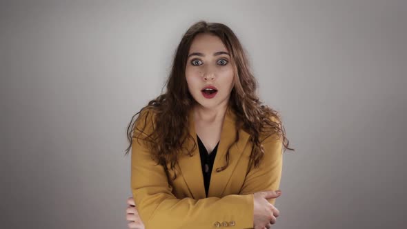 Isolated Portrait of Woman Shocked By Some News Who is Closing Her Mouth By Hand in Slowmo alt