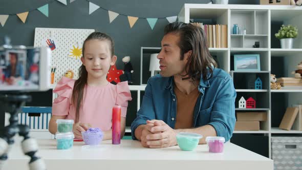 Kid and Father Mixed Race Family Recording Content for Internet Vlog Talking About Playdough Using alt