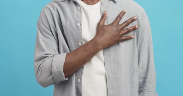 Unrecognizable African American Guy Massaging His Chest, Suffering From Heart Pain alt