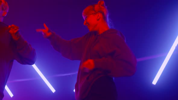 Two Freestyle Dancers Making Hiphop Elements in Club alt