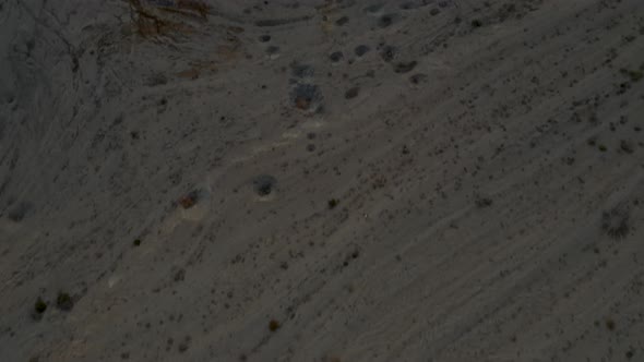 Beautiful sunrise over the Deadsea water, tilt up shot from desert ground to shore of the Deadsea wi alt