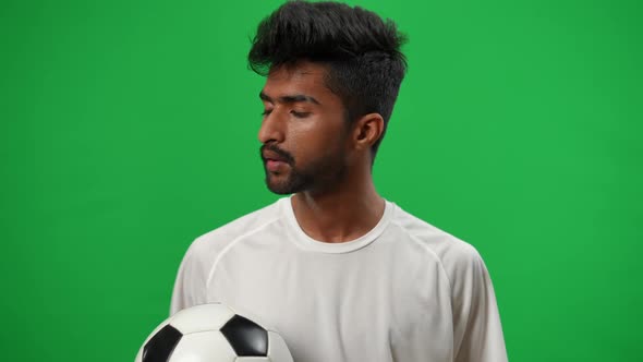 Young Perspiring Middle Eastern Footballer Wiping Sweat Off Forehead Sighing Looking at Camera alt