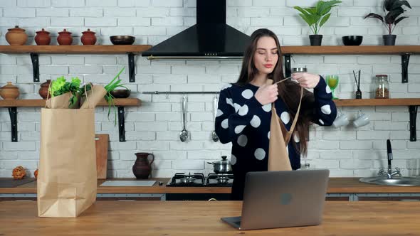 Woman chef comes to kitchen puts apron teaches online culinary webinar in laptop alt