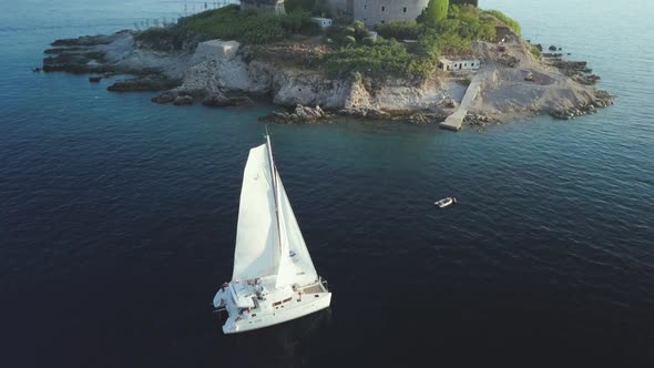 Aerial view of Yacht cruising on the sea or ocean in summer day in Montenegro. alt