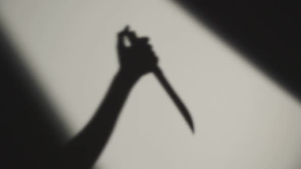 Hand of Killer Stabbing Victim with a Knife