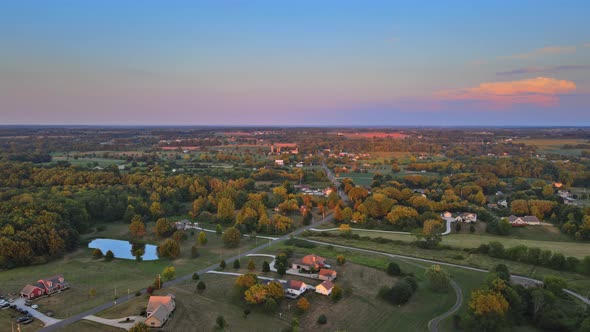 Colorful Summer Landscape with Field Under Scenic Small Village in Sunset Dawn Skyline on Akron Ohio alt