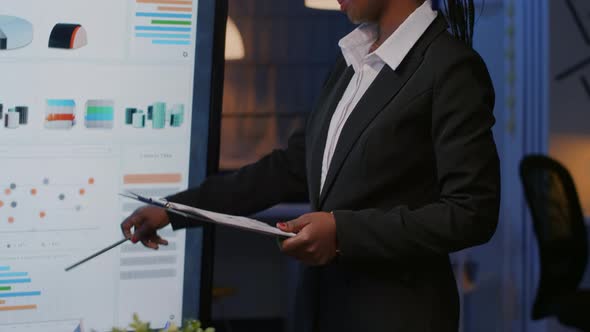African American Executive Manager Standing in Front of Presentation Monitor alt