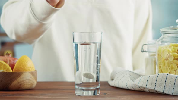 Effervescent Tablets Vitamin C Nutritional Supplements in Glass with Yellow Carbonated Water Sport alt