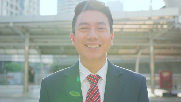 Portrait of Asian smart manager business man feeling happy working in company office in city. alt